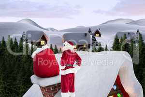 Composite image of santa on cottage roof