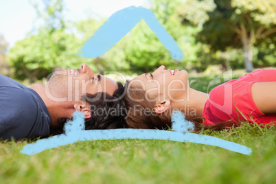 Composite image of two friends looking upwards while lying head