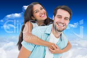 Composite image of happy casual man giving pretty girlfriend pig