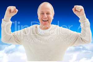 Composite image of happy mature man cheering at camera