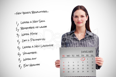 Composite image of businesswoman holding a calendar