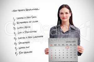 Composite image of businesswoman holding a calendar