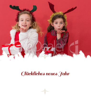 Composite image of festive little girls holding gifts