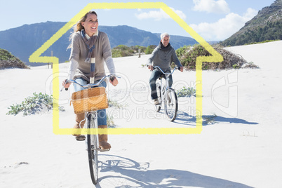 Composite image of carefree couple going on a bike ride on the b