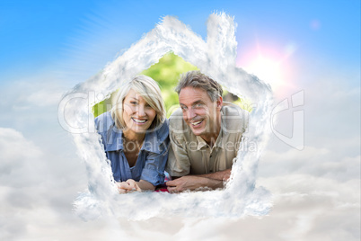 Composite image of couple lying on blanket in park