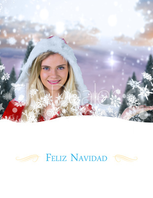 Composite image of pretty girl presenting in santa outfit