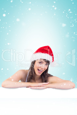 Festive brunette leaning on large poster