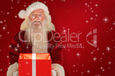 Composite image of father christmas offering a magical christmas