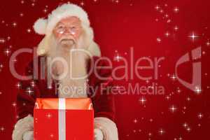 Composite image of father christmas offering a magical christmas