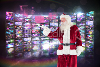 Composite image of santa shows something to camera