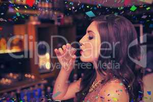 Composite image of pretty brunette drinking a shot