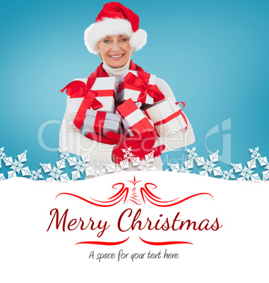 Composite image of festive woman holding gifts