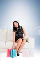 Woman sitting with shopping bags