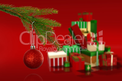 Composite image of red christmas bauble hanging from branch