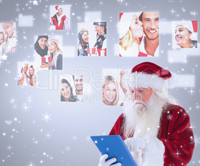 Composite image of santa uses a tablet pc