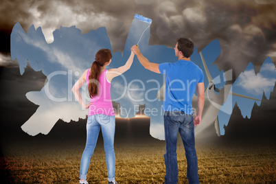 Composite image of couple painting a wall together