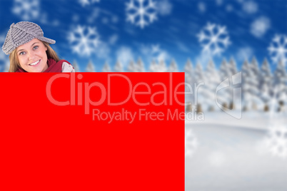 Composite image of happy blonde in winter clothes showing card