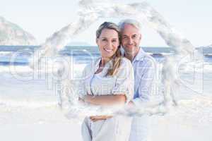 Composite image of happy couple hugging on the beach woman looki
