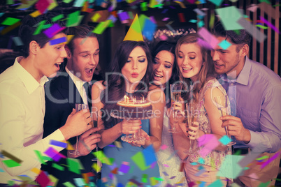 Composite image of attractive friends celebrating a birthday