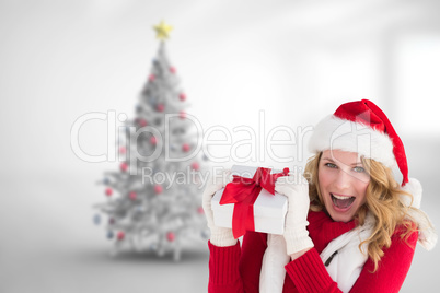 Composite image of pretty santa girl smiling at camera holding g