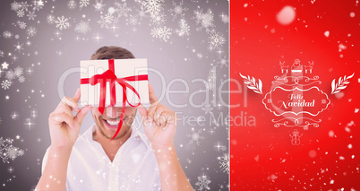 Composite image of man holding gift