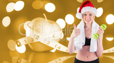 Composite image of festive fit blonde smiling at camera