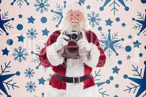 Composite image of santa is taking a picture