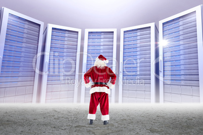 Composite image of santa standing with hands on hips