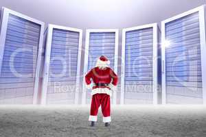 Composite image of santa standing with hands on hips