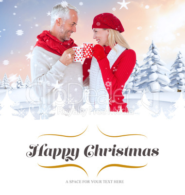 Composite image of happy winter couple with mugs