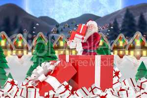 Composite image of santa standing in large gift