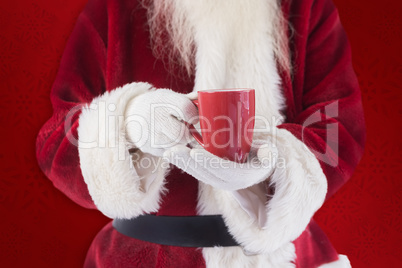 Composite image of santa holds a red cup