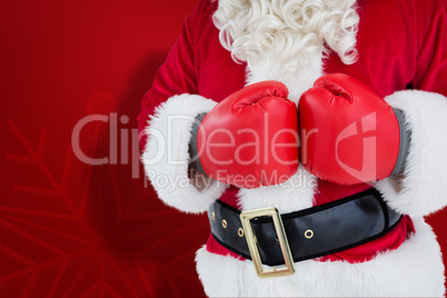 Composite image of mid section of santa with boxing gloves