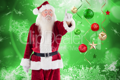 Composite image of santa claus points at something