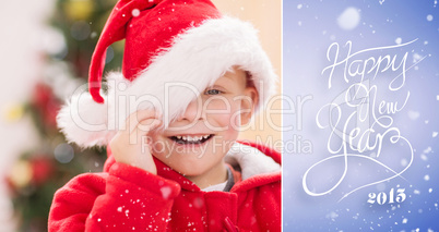 Composite image of festive little boy smiling at camera