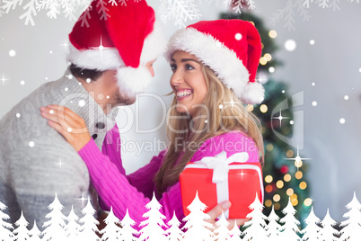 Composite image of smiling couple wearing santa hats