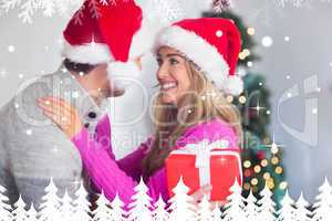 Composite image of smiling couple wearing santa hats