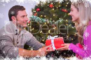 Composite image of sitting couple giving each other presents