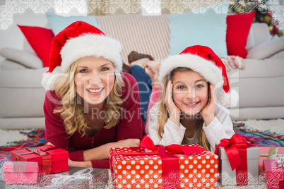 Composite image of festive little girl with mother surrounded by