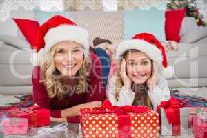 Composite image of festive little girl with mother surrounded by