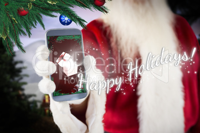 Composite image of santa claus showing smartphone