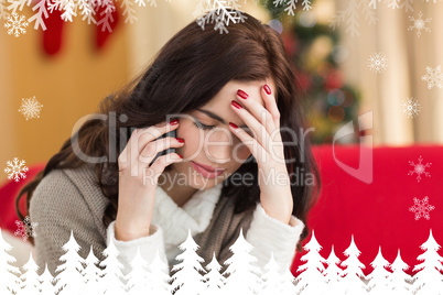 Composite image of concentrated brunette on the phone on christm