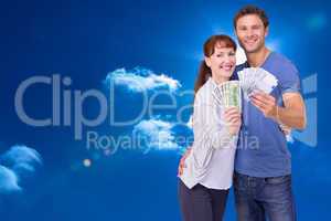 Composite image of couple holding fans of cash