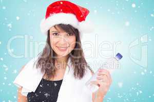 Composite image of festive fit brunette smiling at camera