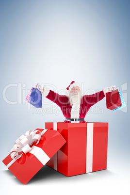 Santa standing in large gift