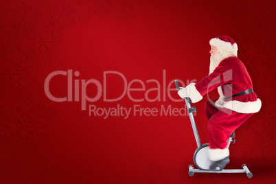 Composite image of santa uses a home trainer