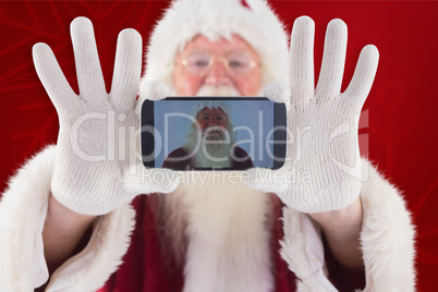 Composite image of santa records himself with a smartphone