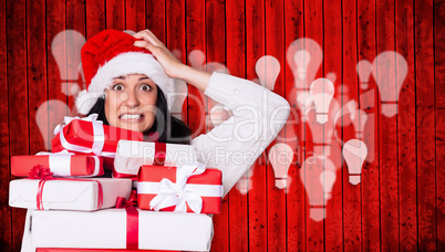 Composite image of shocked woman with christmas presents