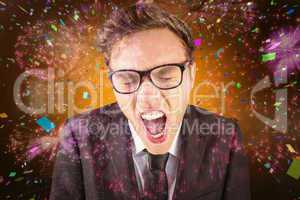 Composite image of young angry businessman shouting at camera