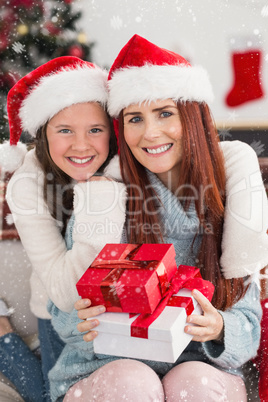 Composite image of festive mother and daughter smiling at camera